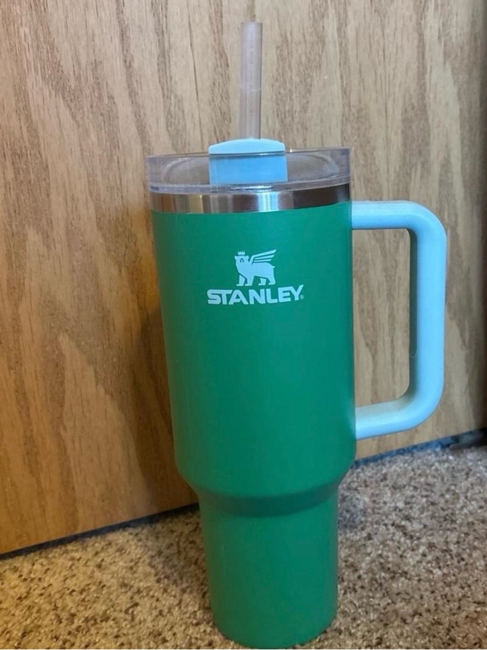 Stanley Green Tumbler with Light Blue Handle and Lid Accent